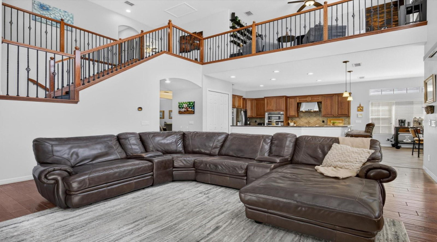 Family room with view into the kitchen and cafe. Loft is observed overhead.