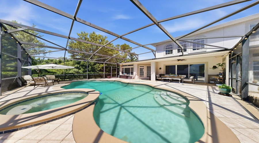 561 Harriswood Court heated pool with spa. Covered lanai with conservation view.