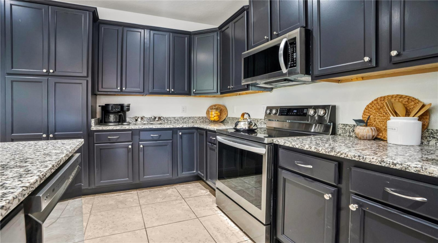 Granite countertops, stainless steel appliances, and abundant cabinetry combine style and function for entertaining large groups with ease.