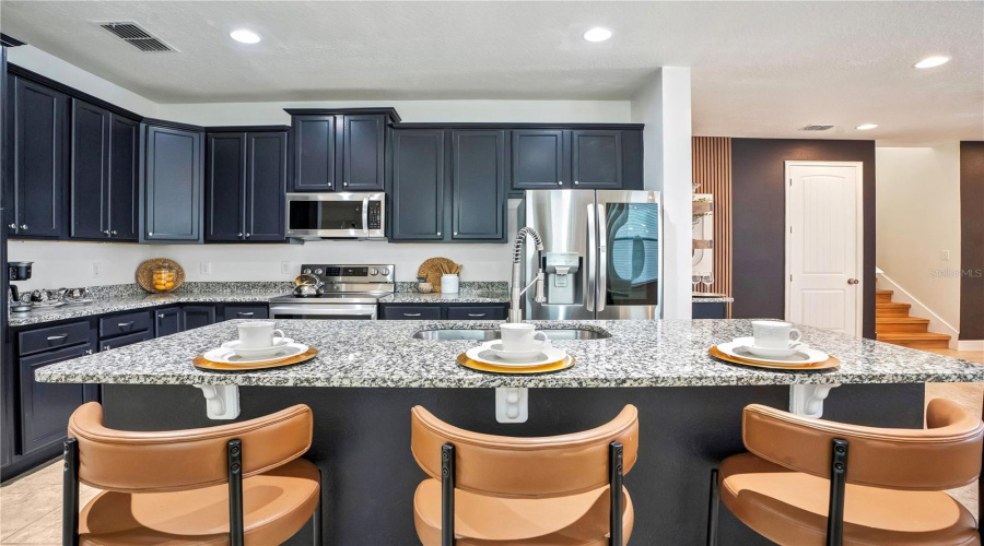 Designed for large families and vacation groups, the open-concept floor plan seamlessly connects the kitchen, dining, and living spaces.