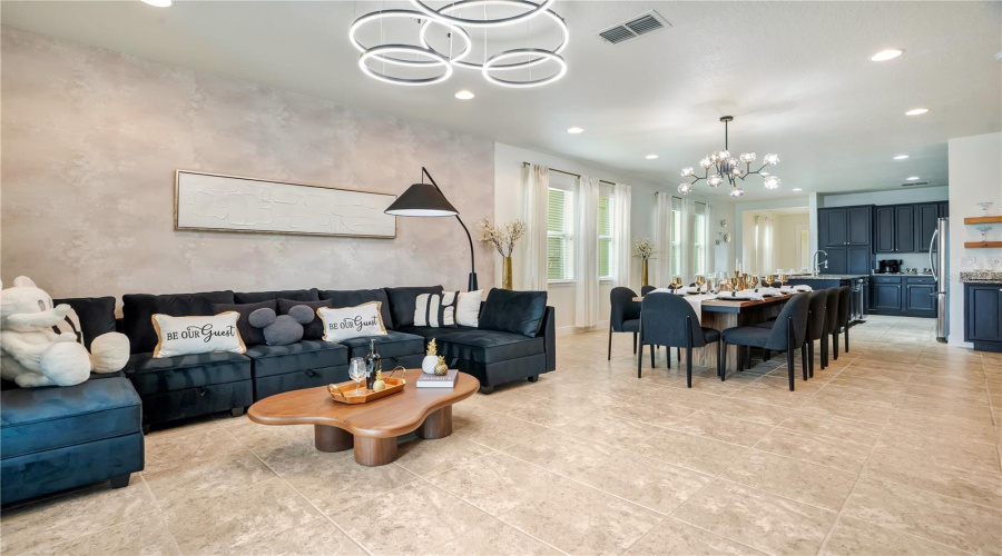 Comfortably furnished with seating for large groups, the open-concept great room flows effortlessly into the dining and kitchen areas for easy entertaining.