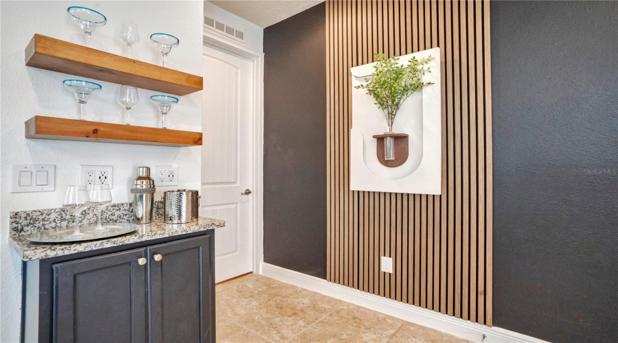 A stylish beverage station with wine refrigerator offers the perfect place for morning coffee, afternoon refreshments, or evening cocktails.