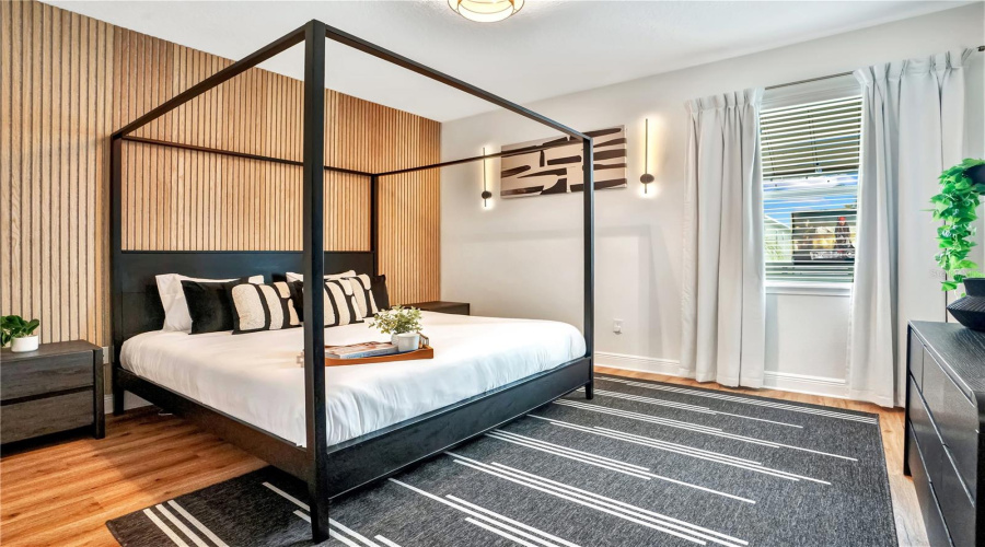 One of two spacious primary suites offers contemporary design, abundant natural light, and a peaceful retreat for owners and guests alike.