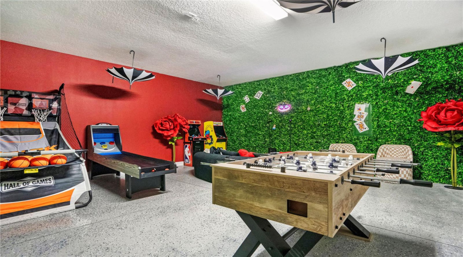 Challenge family and friends to foosball, air hockey, and arcade games inside this whimsical Wonderland-inspired game room where imagination takes center stage.