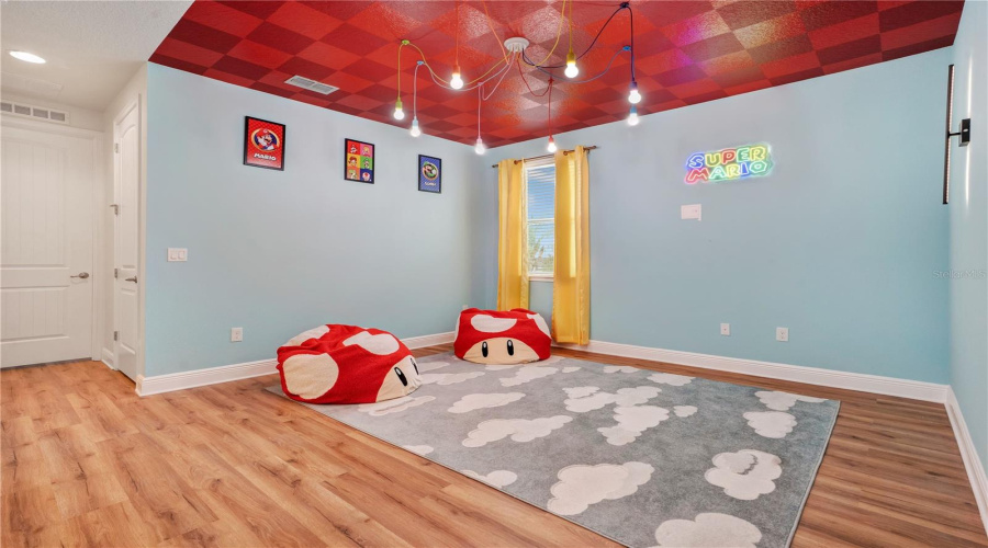 Mario Kart: Rainbow Road Loft. A colorful gaming-inspired retreat where little racers can imagine crossing the finish line before heading out for another day of adventure.