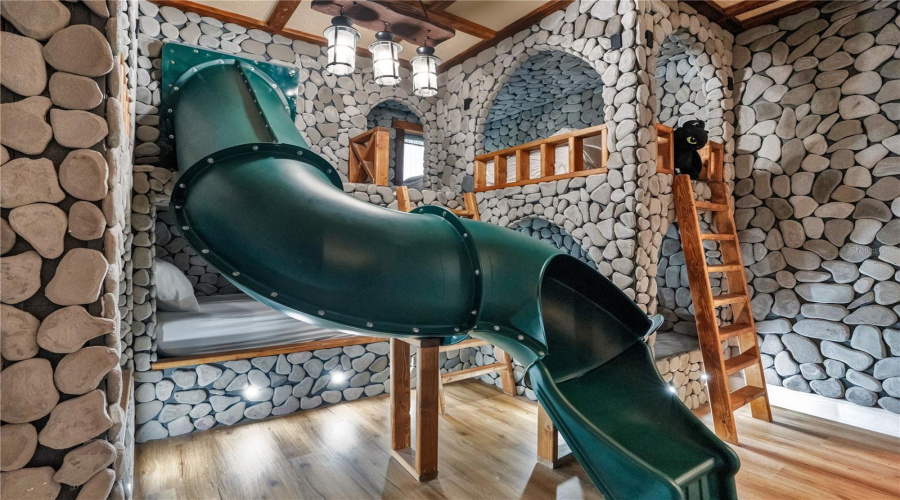 Toothless & Berk's Hideaway. Custom-built bunk beds, handcrafted rockwork, and an exciting slide transport guests into a world inspired by dragons and Viking adventure.