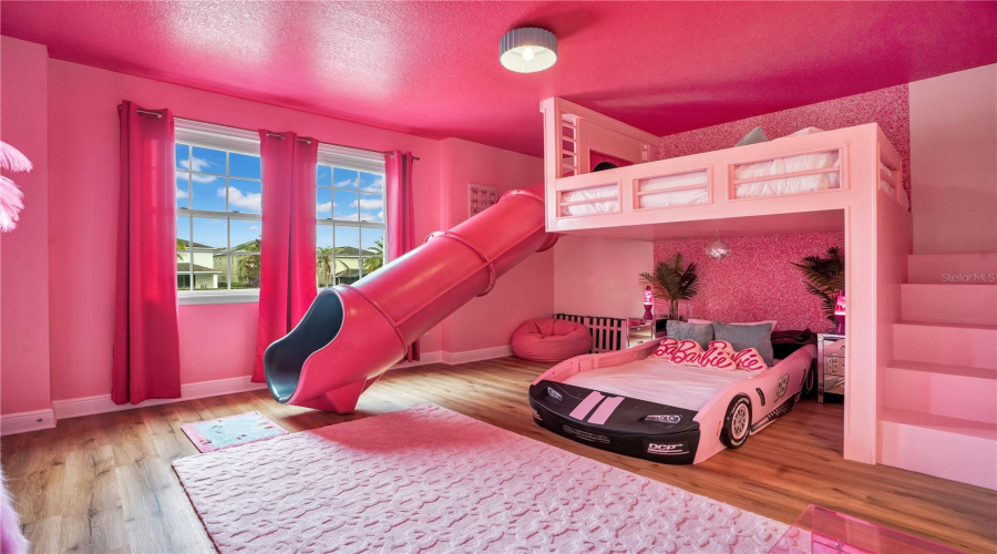 Dream in Barbie. This unforgettable custom suite features glamorous décor, whimsical details, custom bunks, and its own slide leading to a coordinating Barbie-inspired bathroom.