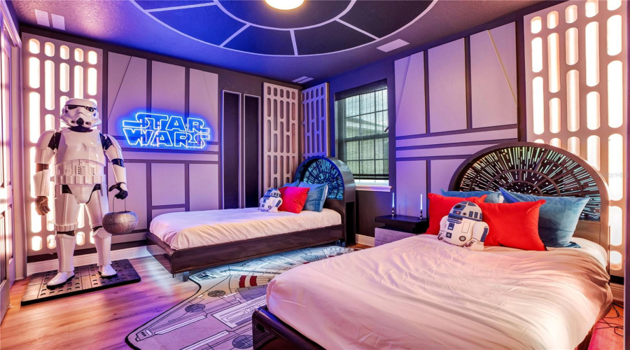 Journey to a Galaxy Far, Far Away. Custom Millennium Falcon-inspired lighted beds, dramatic lighting, immersive galactic décor, and a life-sized talking Stormtrooper transport guests into an unforgettable Star Wars adventure.
