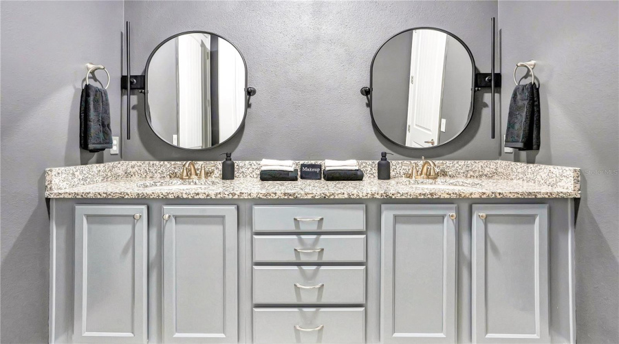 A beautifully appointed ensuite jack n jill style bath between the Harry Potter Room and Star Wars Room features dual vanities, generous storage, and modern finishes designed for comfort and convenience.