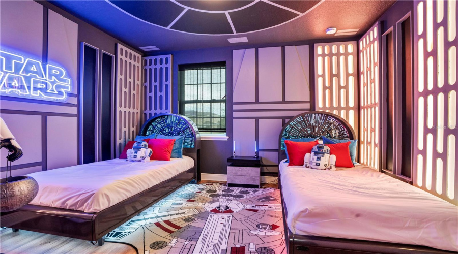 Journey to a Galaxy Far, Far Away. Custom Millennium Falcon-inspired beds, dramatic lighting, and immersive galactic décor make this one of The WonderHouse's signature experiences.