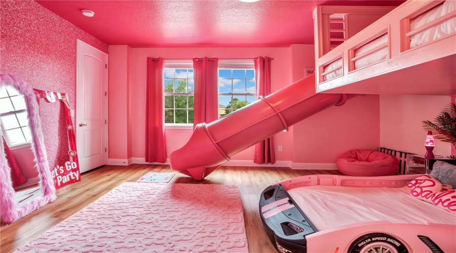 Dream in Barbie. Bright, glamorous, and full of personality, this custom suite features a whimsical slide and playful design that turns every stay into a dream vacation.
