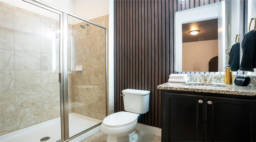 The spacious primary ensuite features a walk-in shower, modern vanity, and elegant finishes designed for comfort and convenience.