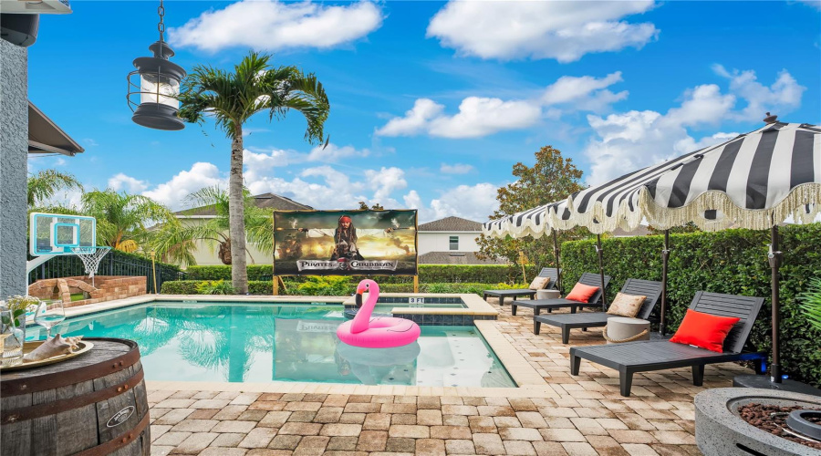 The fully fenced backyard offers exceptional privacy while providing multiple spaces for swimming, relaxing, and outdoor fun.