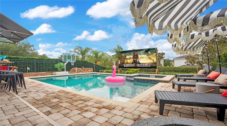 As the sun sets, the backyard transforms into a private outdoor cinema where family movie nights become unforgettable memories beneath the stars.