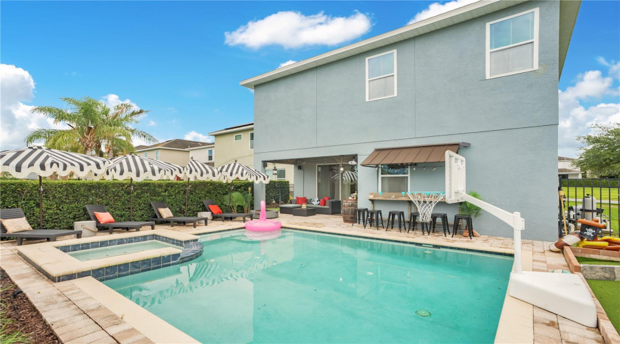 Designed for gathering, the spacious pool deck offers comfortable lounge seating, spa, and plenty of room for everyone to enjoy.