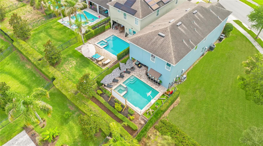 Aerial view showcasing the home's private pool, spacious backyard, and premium location within Encore at Reunion Resort.