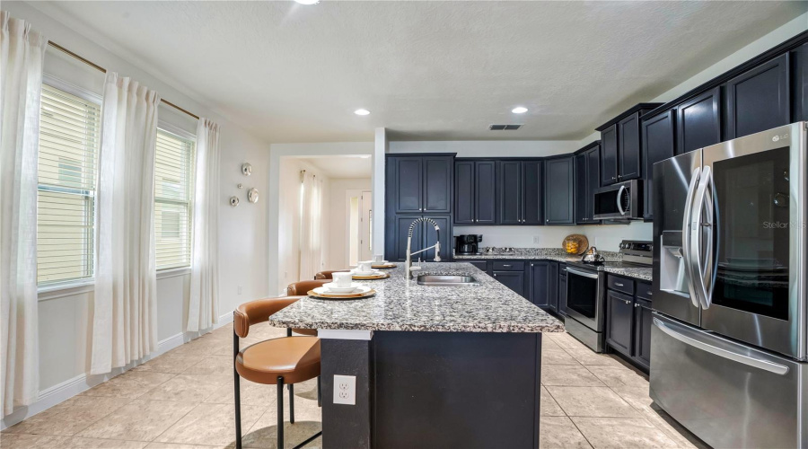 Natural light fills the spacious kitchen and living area, creating an ideal gathering place for preparing meals, entertaining, and reconnecting between adventures.
