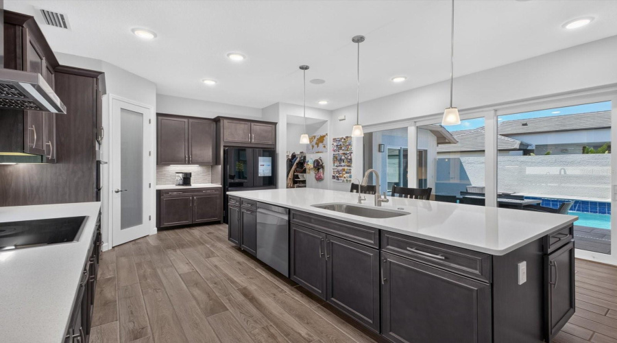 Dining and kitchen open to pool area