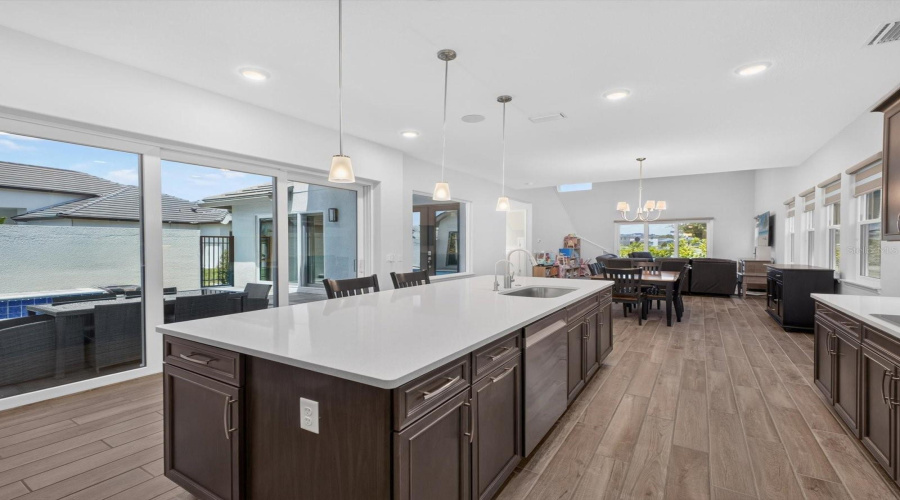 Dining and kitchen open to pool area