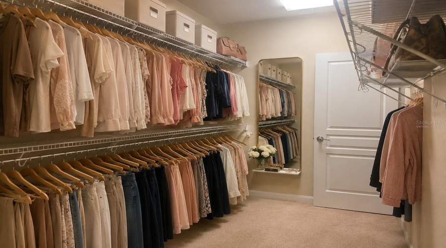 Virtually staged Oversized walk-in closet in primary bedroom