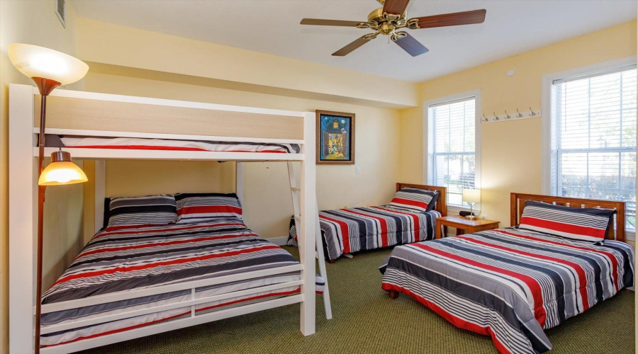 Bedroom with queen bunk beds and two double beds