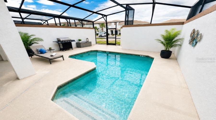 Virtually staged screened pool and patio area highlighting a private outdoor space for relaxing, entertaining, and enjoying the Florida sunshine.