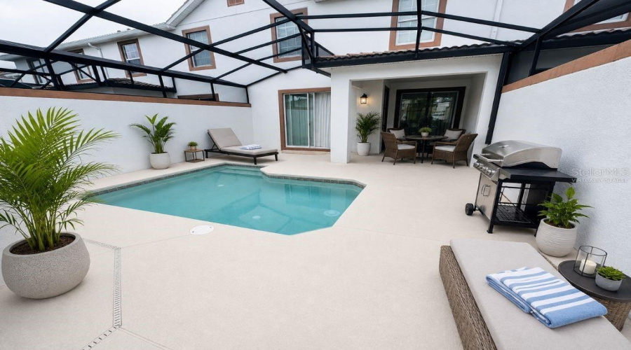 Virtually staged screened pool and patio highlighting a private outdoor retreat with space for lounging, dining, and entertaining.