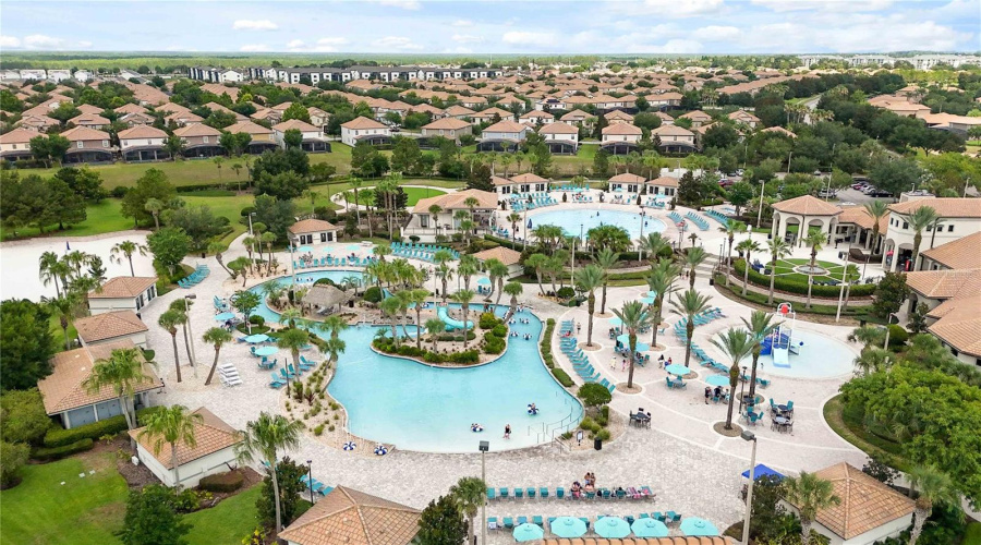Aerial view of the Oasis Club amenities showcasing resort-style pools, lounge areas, water features, and tropical outdoor spaces for guests to enjoy.