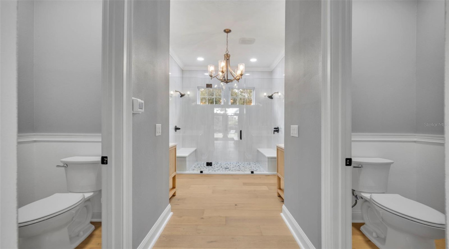 First Floor Primary Bathroom duel toilet closets enclose