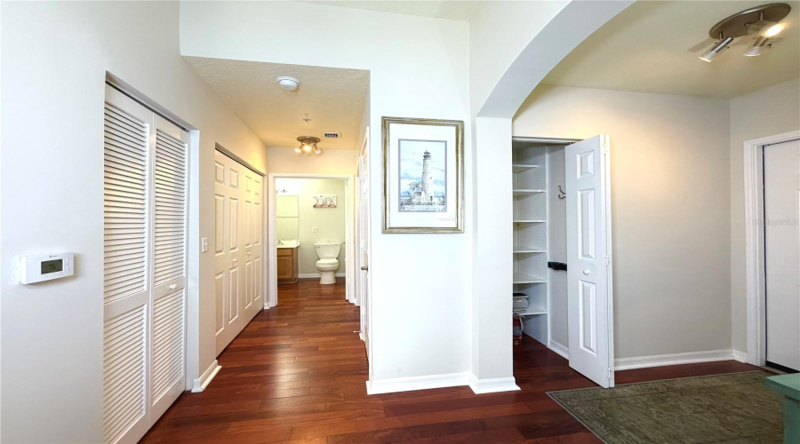 Hall going to second bedroom & bath with entry way closet