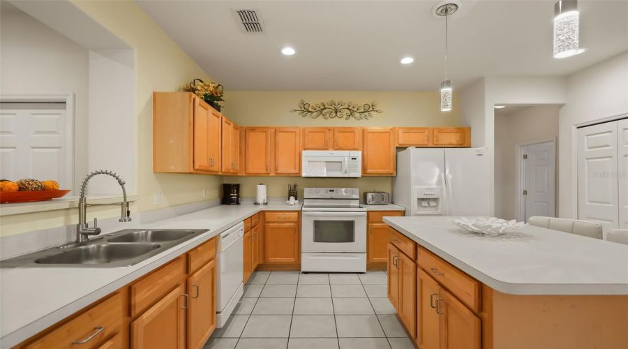 Well-equipped kitchen with abundant storage, white appliances, and an efficient layout for everyday living or vacation rentals.