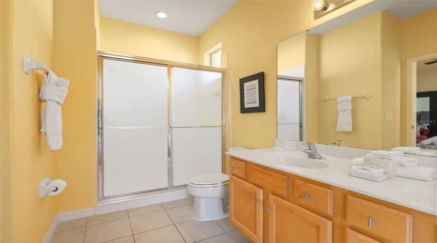 Spacious primary bathroom with a walk-in shower, large vanity, and plenty of natural light.