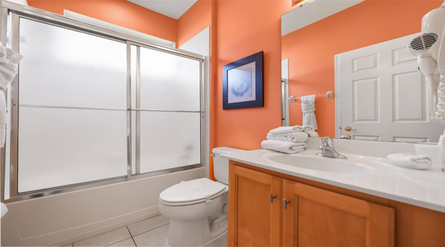 Private guest bathroom with a single vanity and tub/shower combination.
