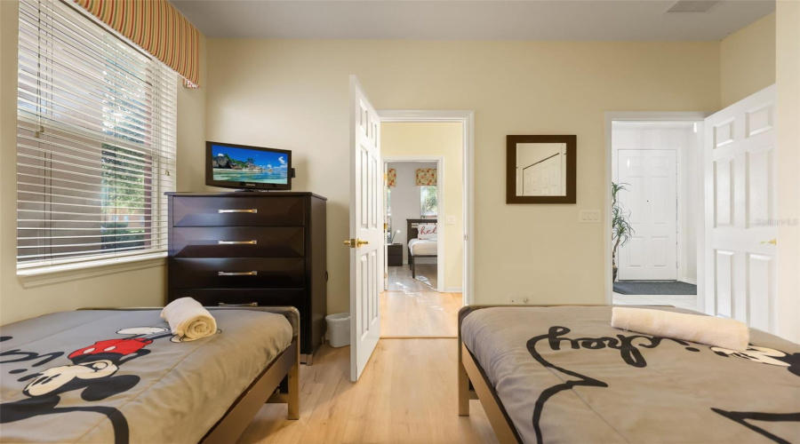 Alternate view of the guest bedroom showcasing comfortable accommodations and ample storage space.
