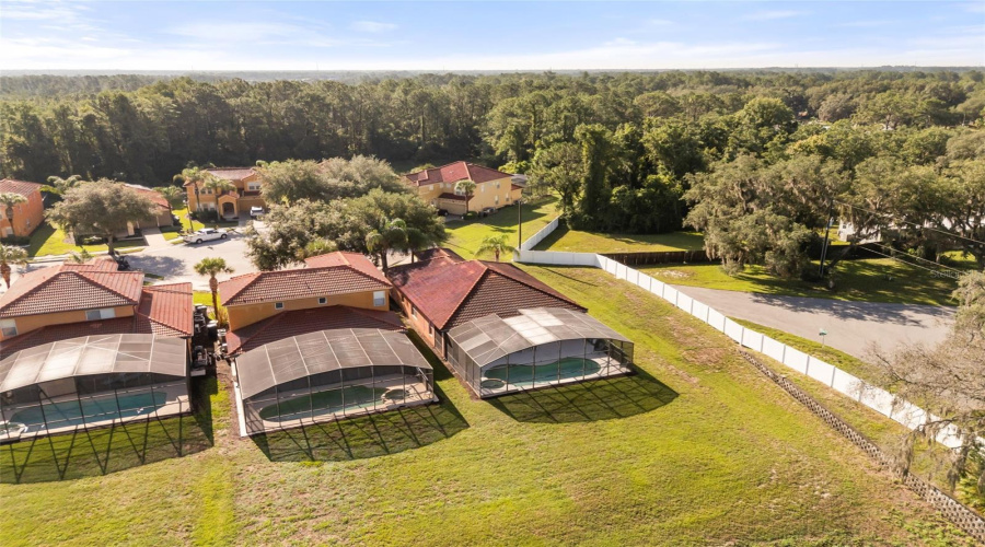 Elevated aerial view showcasing the home's private rear setting and location within Watersong Resort.