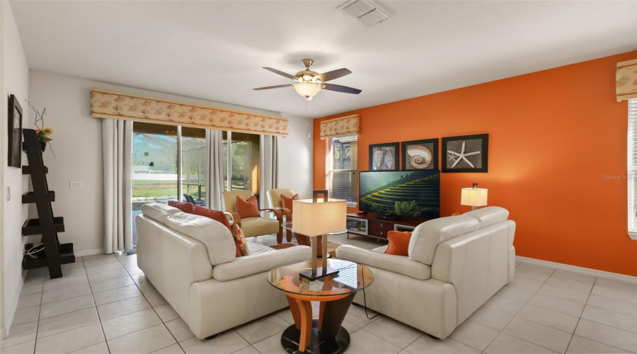 Alternate view of the family room showcasing the open floor plan and easy access to the kitchen and dining space.