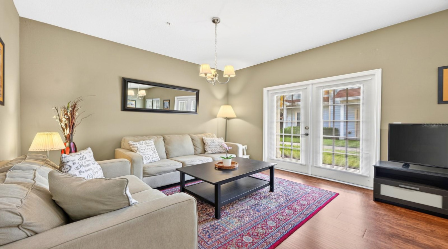 French doors off the living area open to a covered side porch.