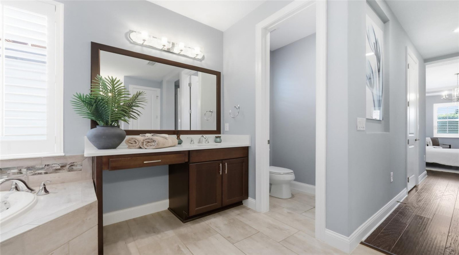 Her Vanity with Natural Light, Ample Counter Space & Seating Nook