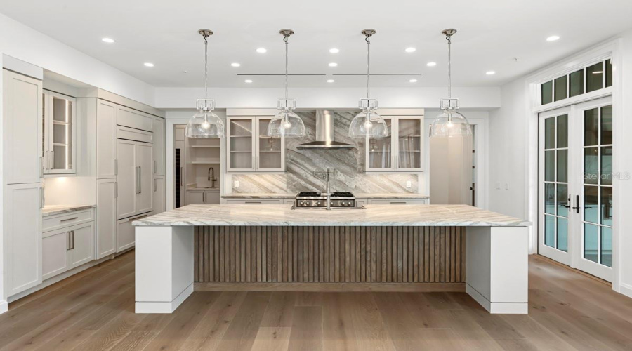 Gourmet kitchen with frameless contemporary cabinetry and alarge prep island