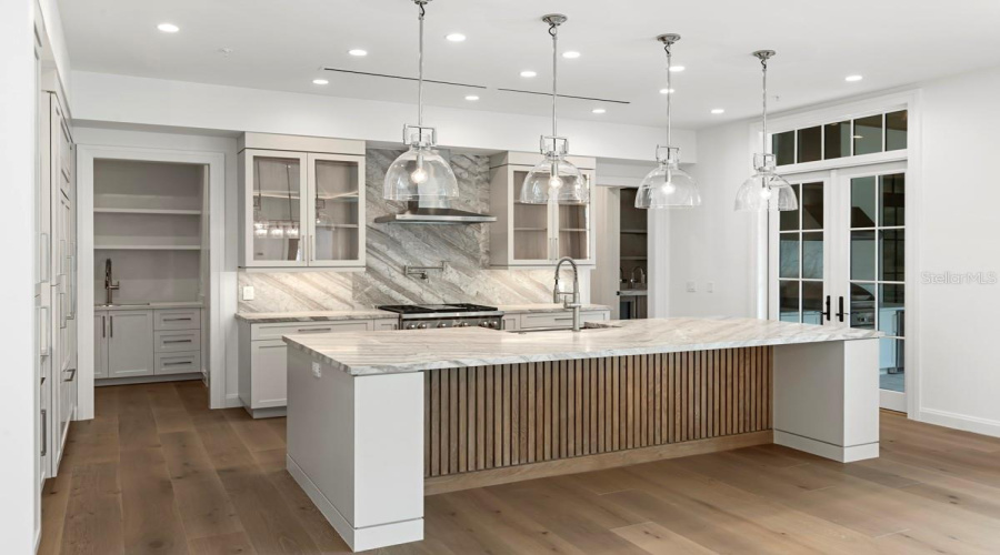 Gourmet kitchen with frameless contemporary cabinetry and alarge prep island