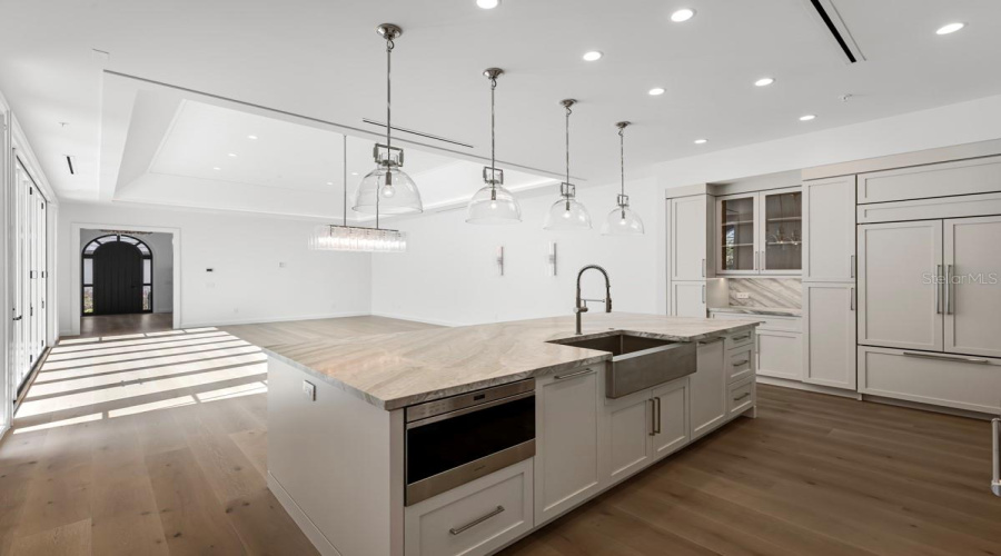 Gourmet kitchen with frameless contemporary cabinetry and alarge prep island