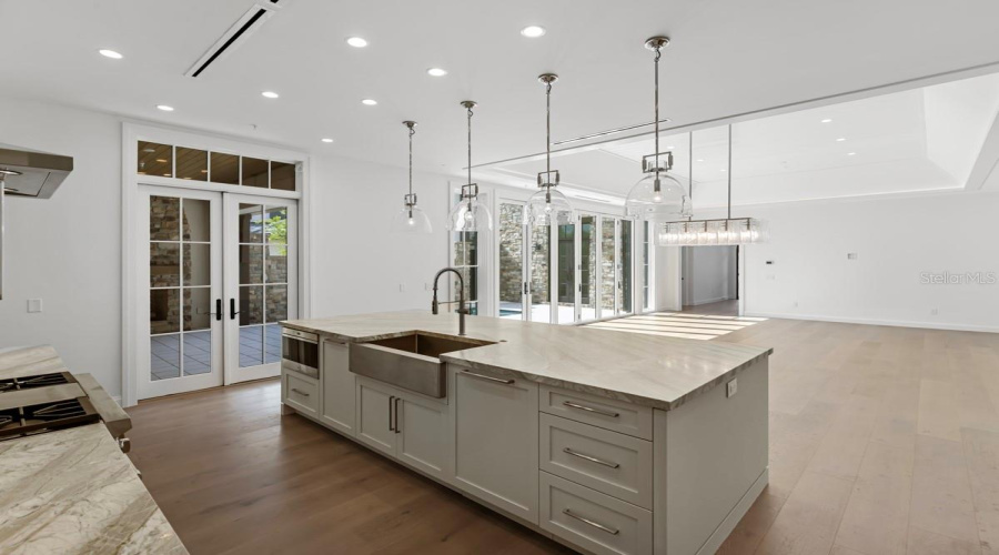 Gourmet kitchen with frameless contemporary cabinetry and alarge prep island