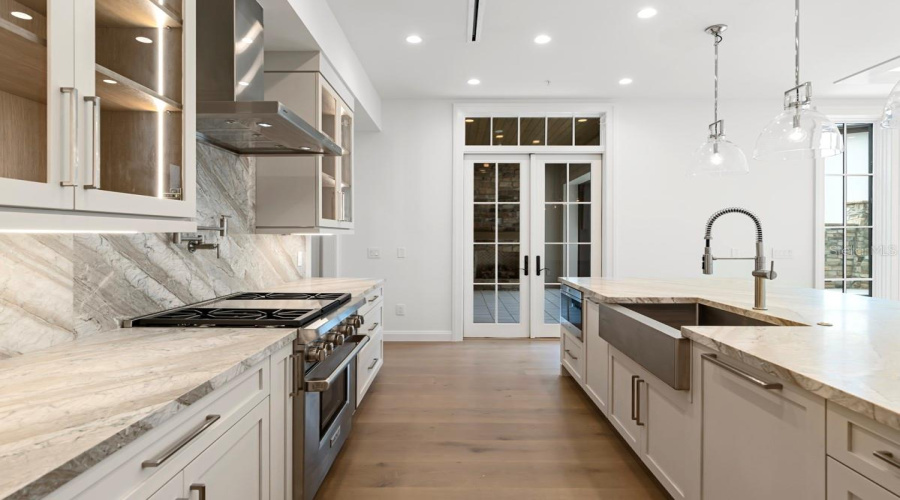Gourmet kitchen with frameless contemporary cabinetry and alarge prep island