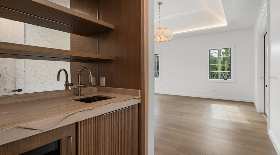 Luxurious primary bedroom suite with morning bar