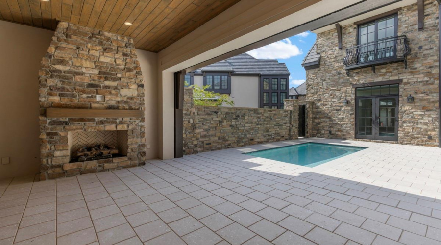 Outdoor living area with summer kitchen and heated lounging pool
