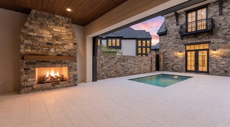 Outdoor living area with summer kitchen and heated lounging pool