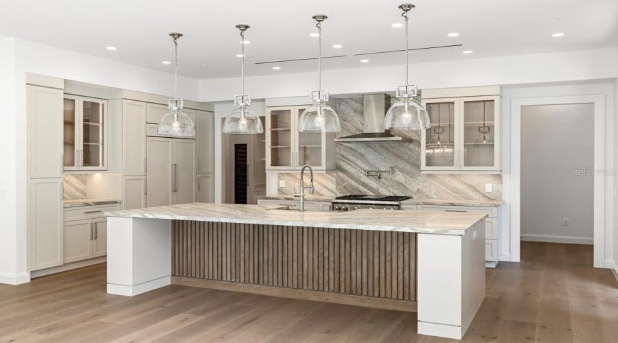 Gourmet kitchen with frameless contemporary cabinetry and alarge prep island