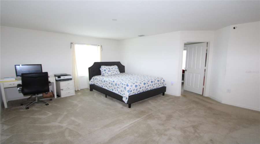 Spacious second-floor bonus area, perfect for a home office, media room, playroom, or additional living space.