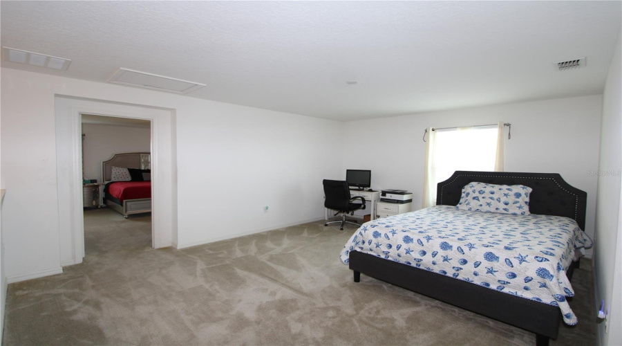 Spacious second-floor bonus area, perfect for a home office, media room, playroom, or additional living space.