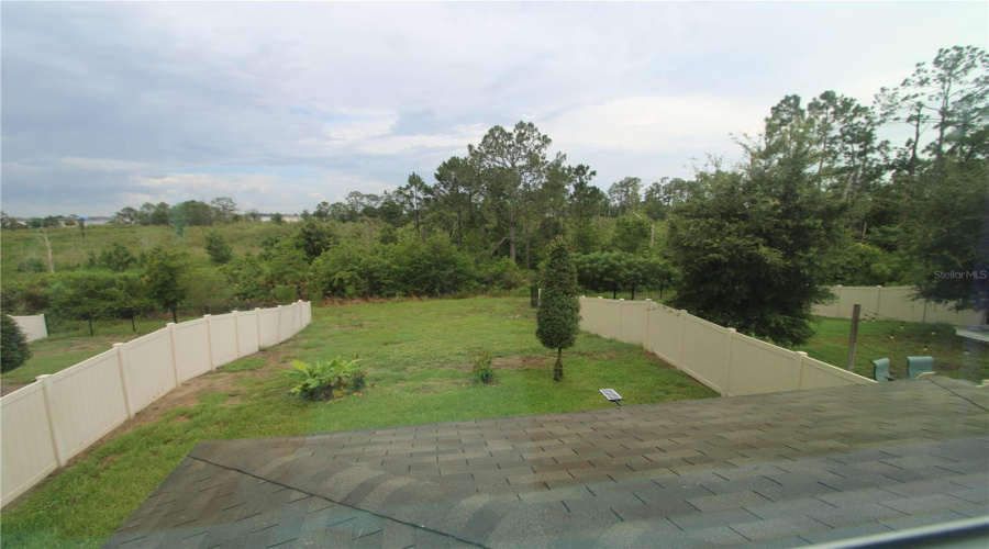 Peaceful views from the primary suite overlooking the backyard